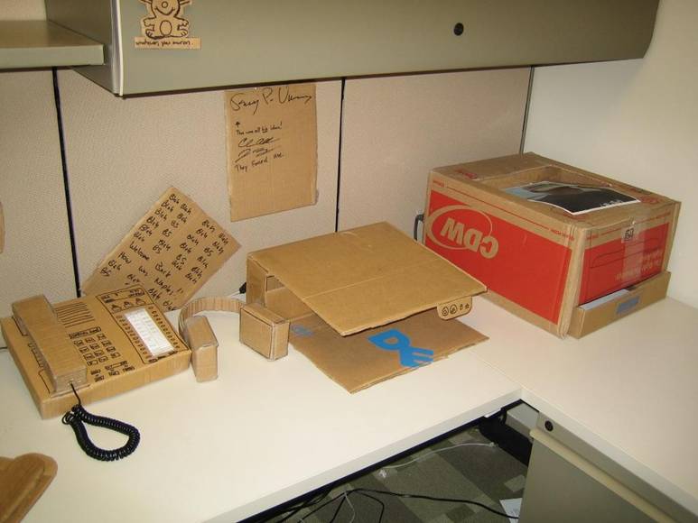 office prank - cardboard boxes as laptop stand
