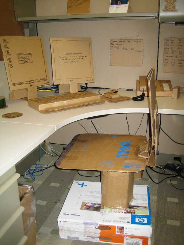 office prank - cardboard boxes as desk chair